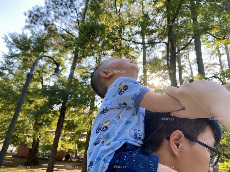 On father’s shoulder 