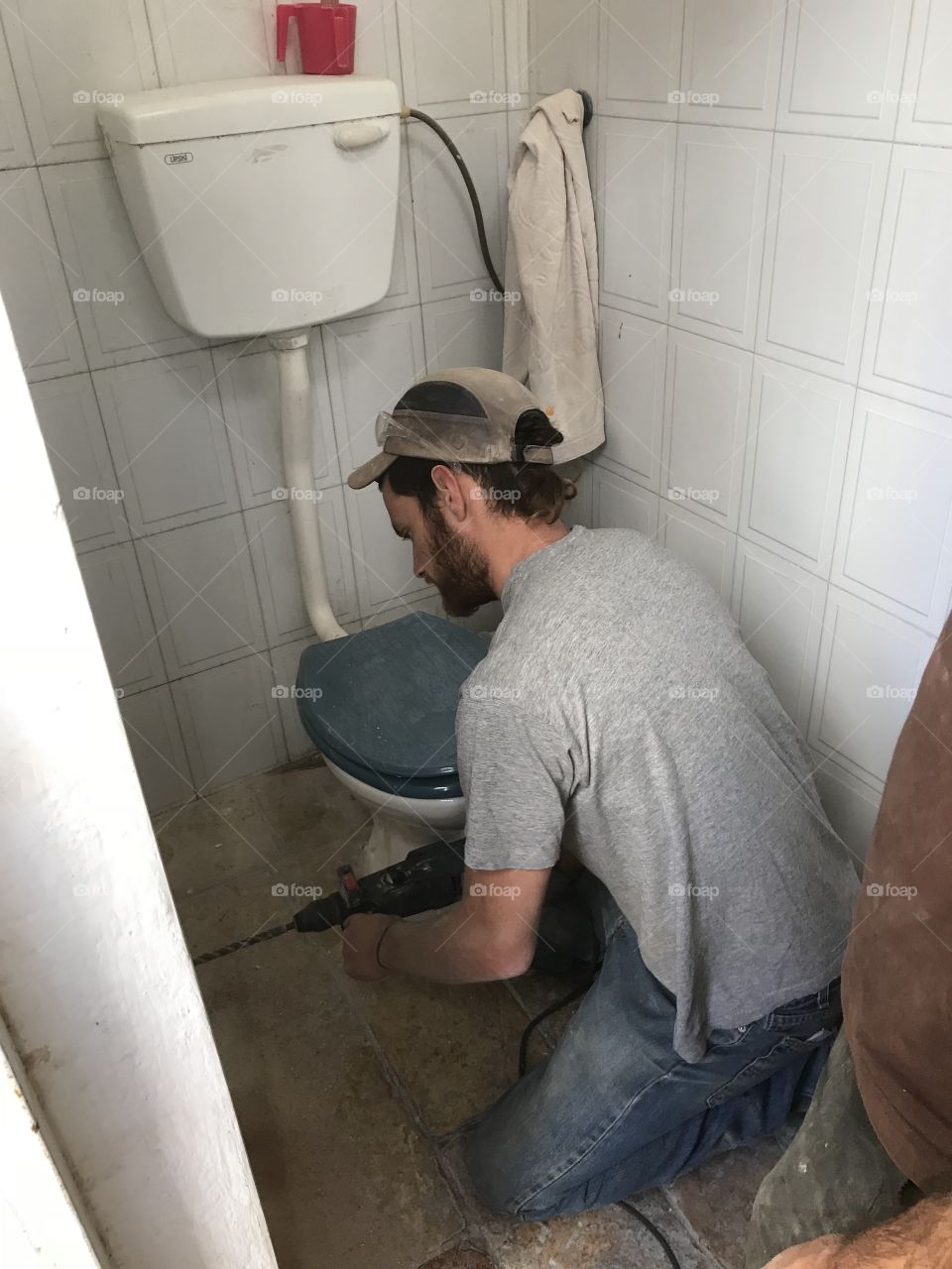 Construction worker remodeling bathroom 