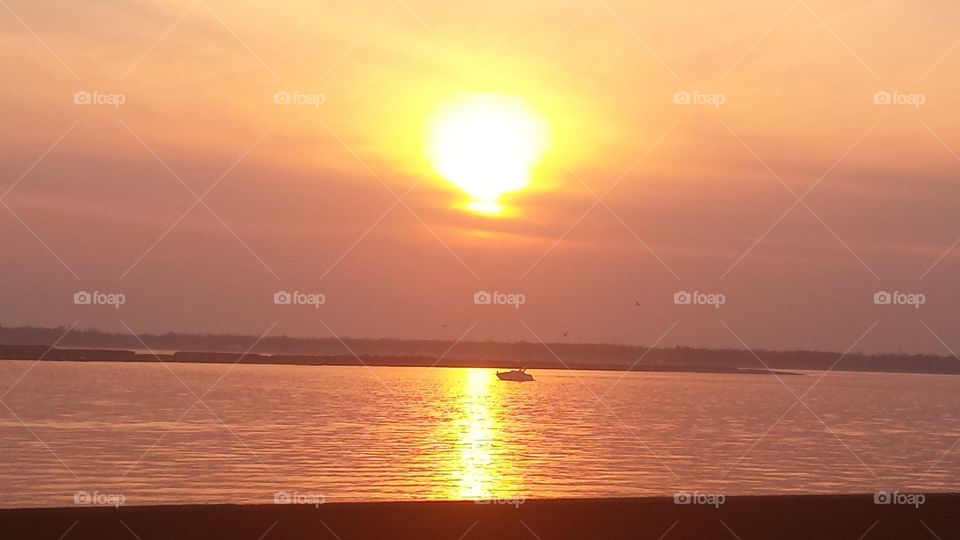 sunset on boat in water. sunset on boat in water