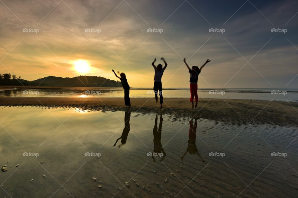Childrens of Independent. Reflections of 3 independent childrens during sunrise at Cherating Beach Pahang.