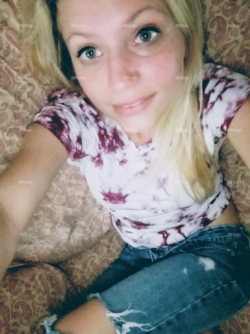 sexy blond woman wearing tie dye taking a selfie