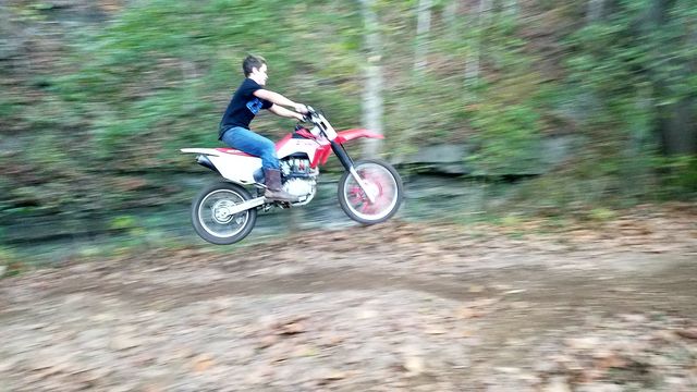 son jumping his dirt bike