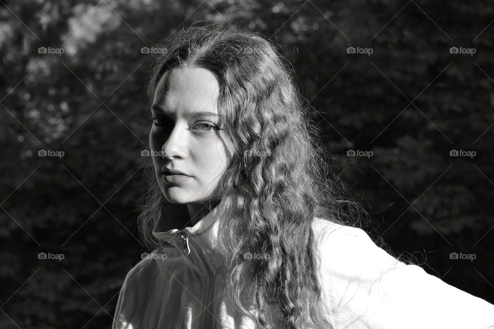 girl beautiful portrait in sunlight black and white background