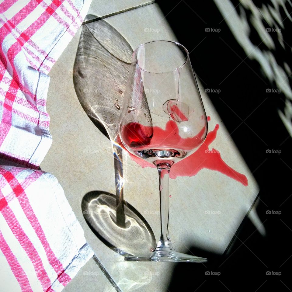 Broken wine glass. Party is ended, sun is rising.