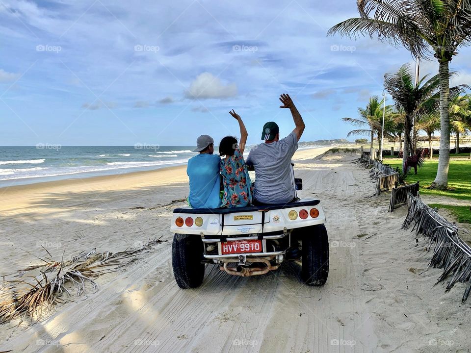 Family riding a buggy on the beach