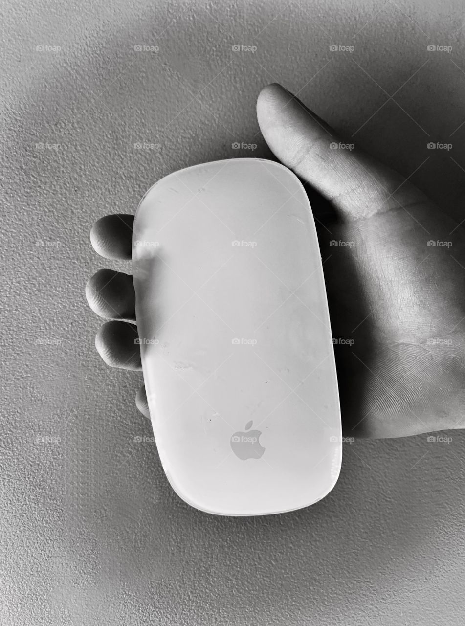 Holding an apple computer mouse in hand 
