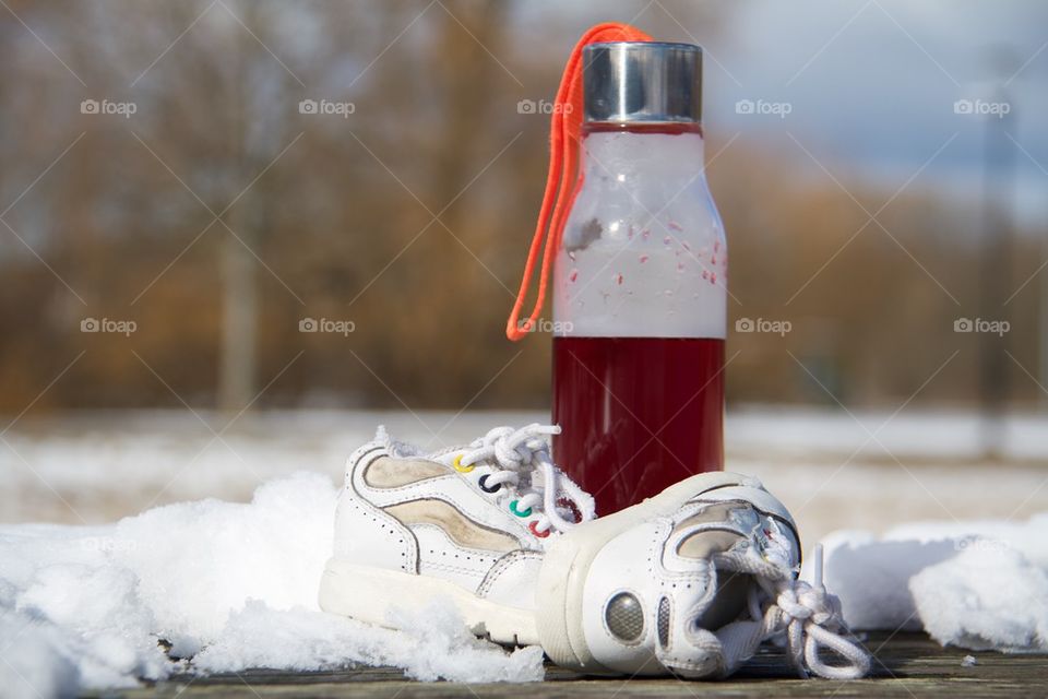 Children shoes in the snow 