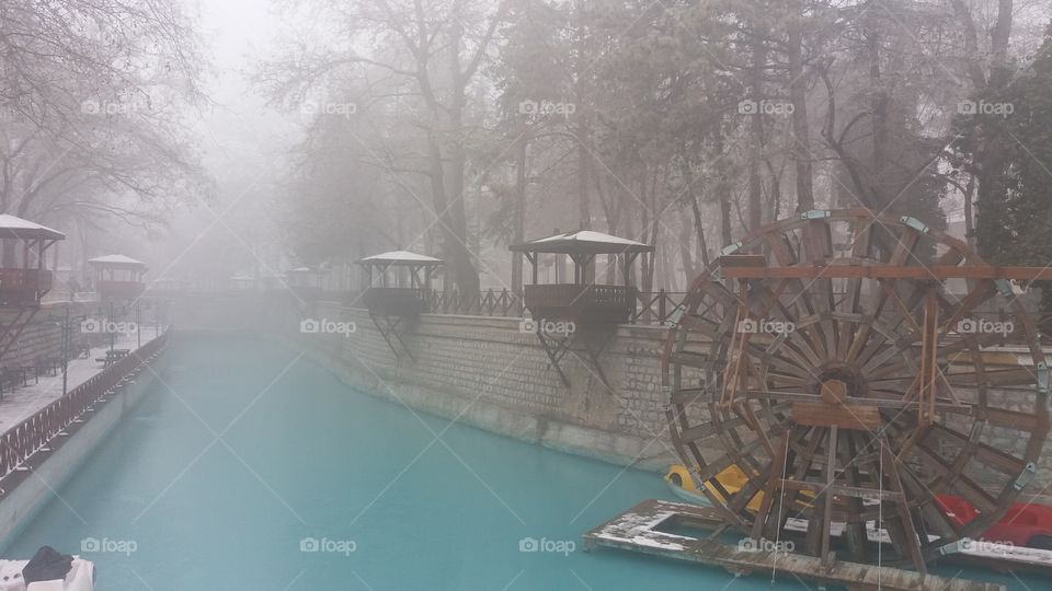 water wheel and arbors in the Park in winter