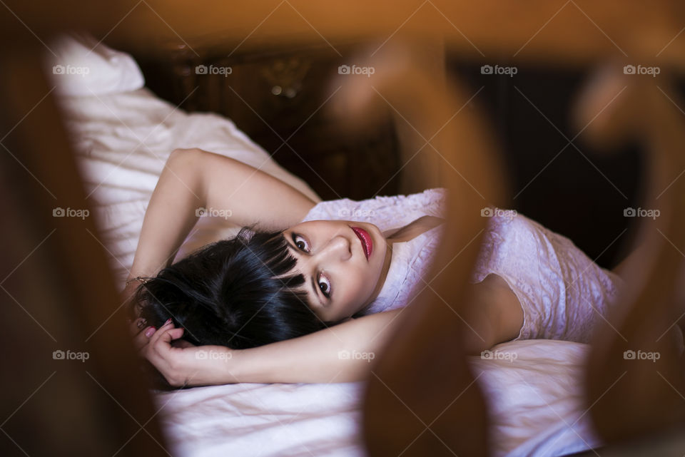 Woman lying on bed