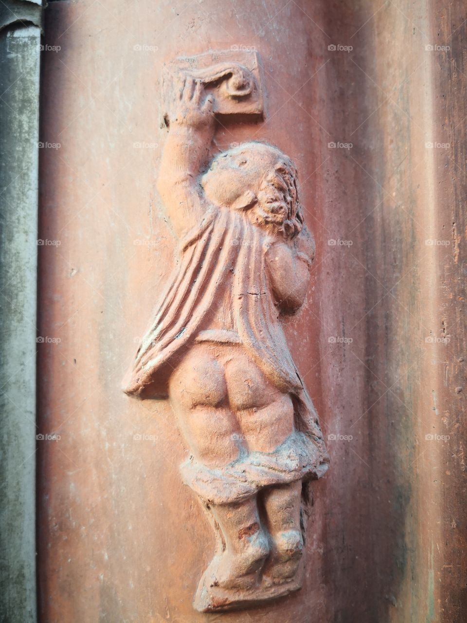 Building facade. Child trying to open the door.