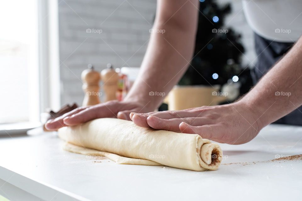 man cooking cinnamon roll