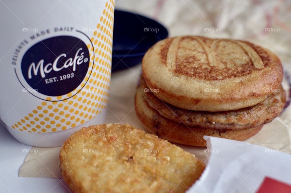 McDonald’s Mc Café sausage McGriddle hash brown close up side flat lay