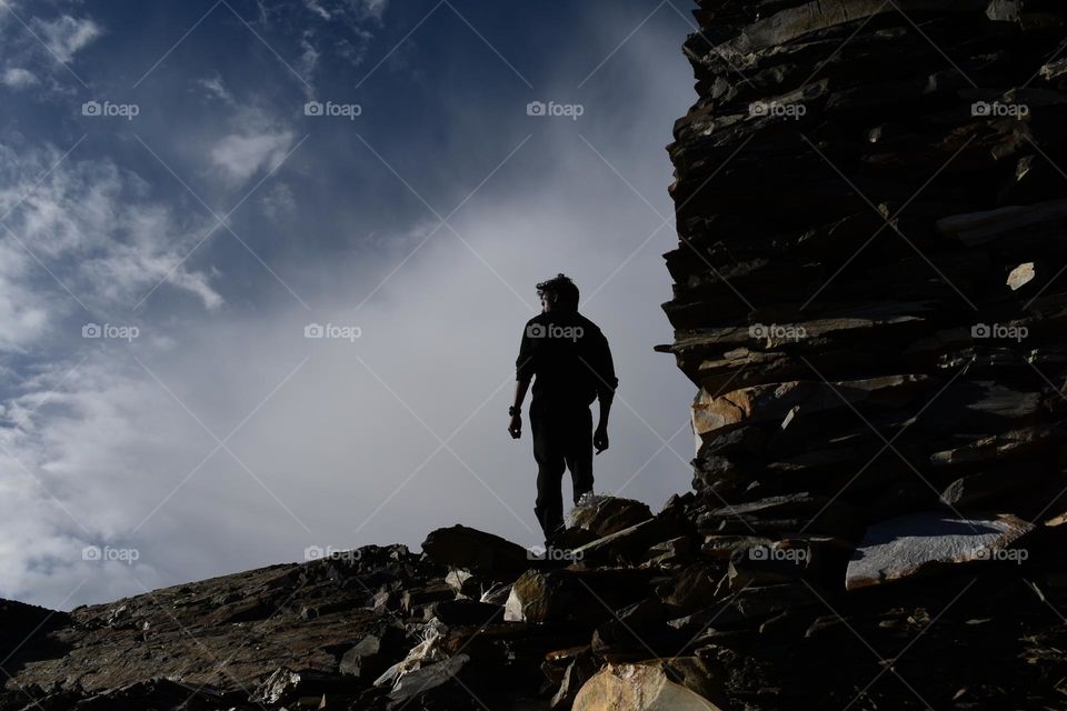 single man standing on the top of the hill