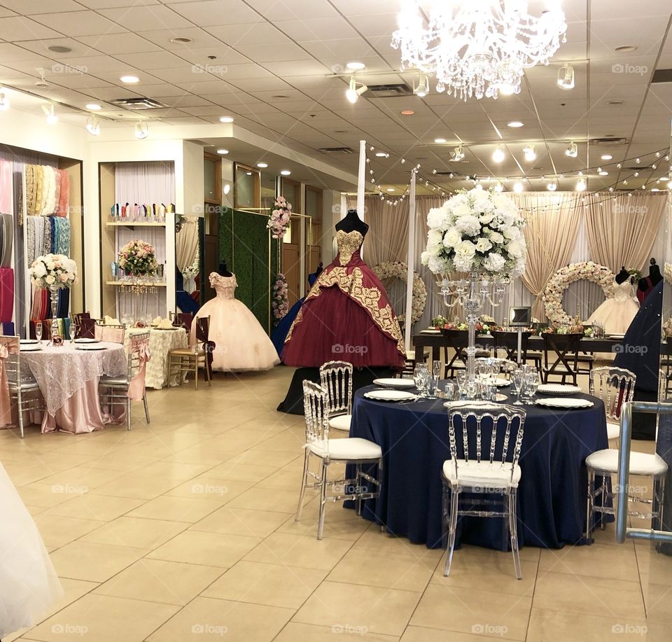 Retail store for quinceañera and wedding celebrations with dresses, tabletop, furniture, chandelier, details 