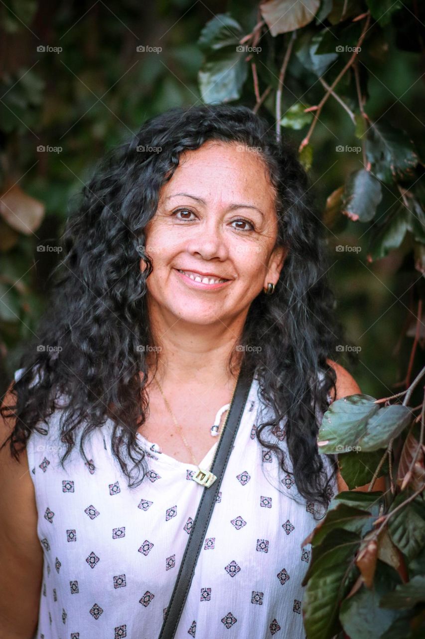 Middle-aged woman with healthy dark curly hair