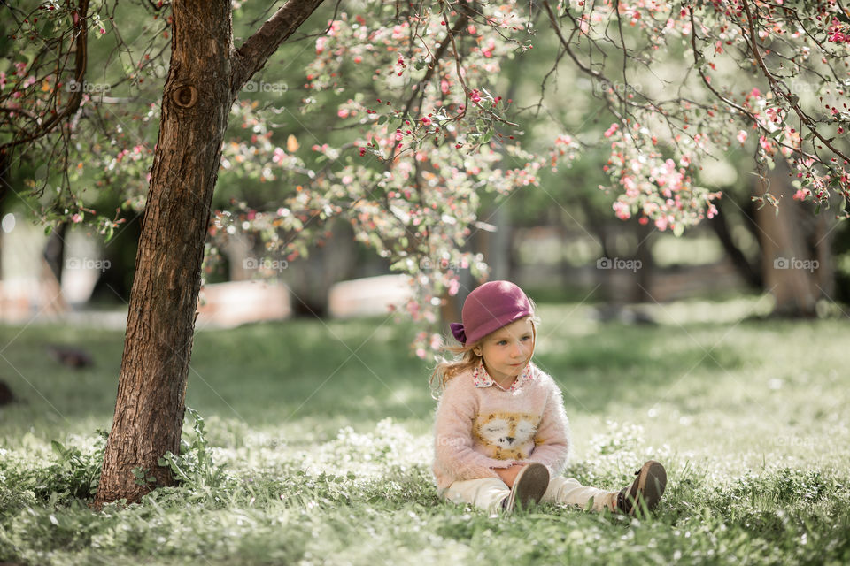 Cute Little girl in a blossom park