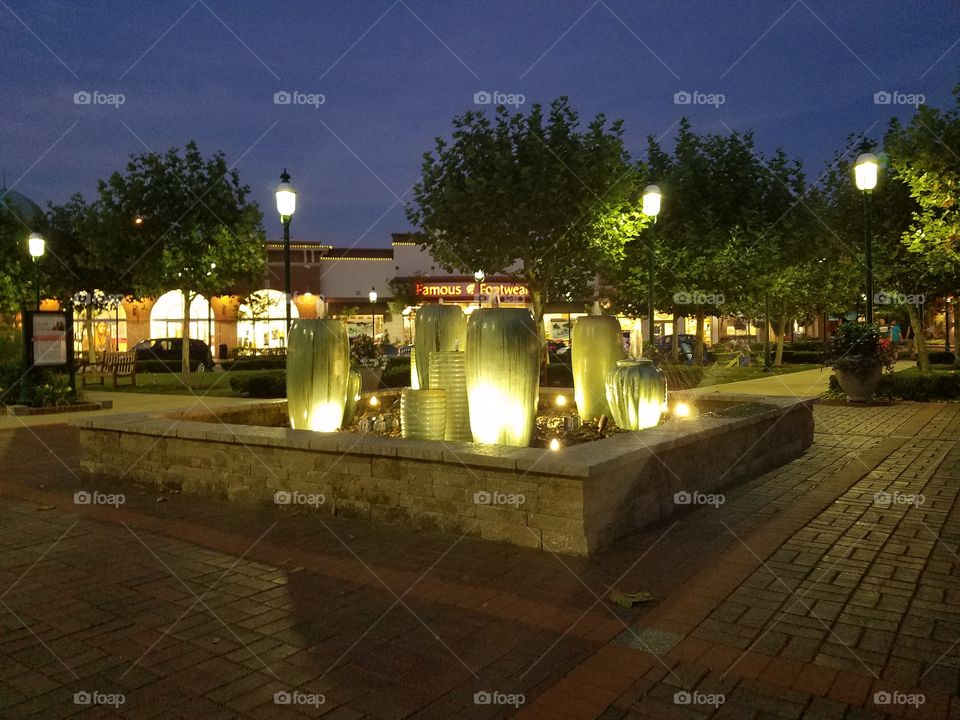 fountain lit up at the waterfront