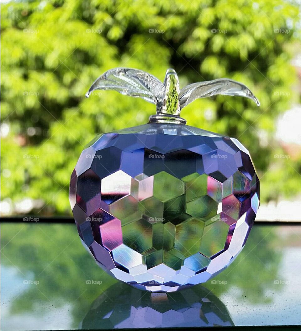 faceted apple. colours on faceted glass apple