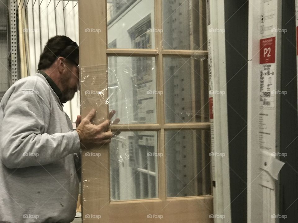 Man looking at a door for home improvements 