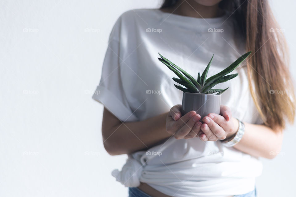 A lady holding a cactus 