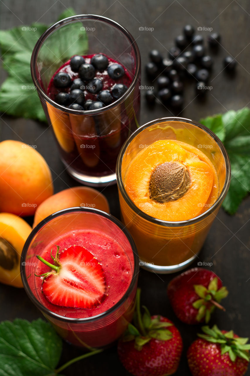 Three glass of different fruit smoothie