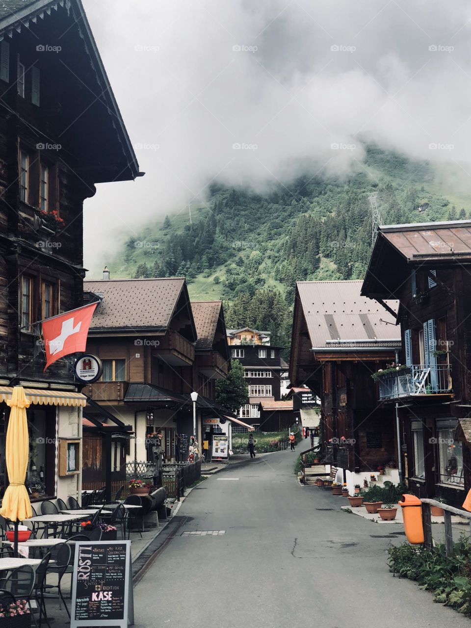 A beautiful cloudy top of mountain in Switzerland with architecture on both sides. Switzerland really does capture the heart of everyone that visits.
