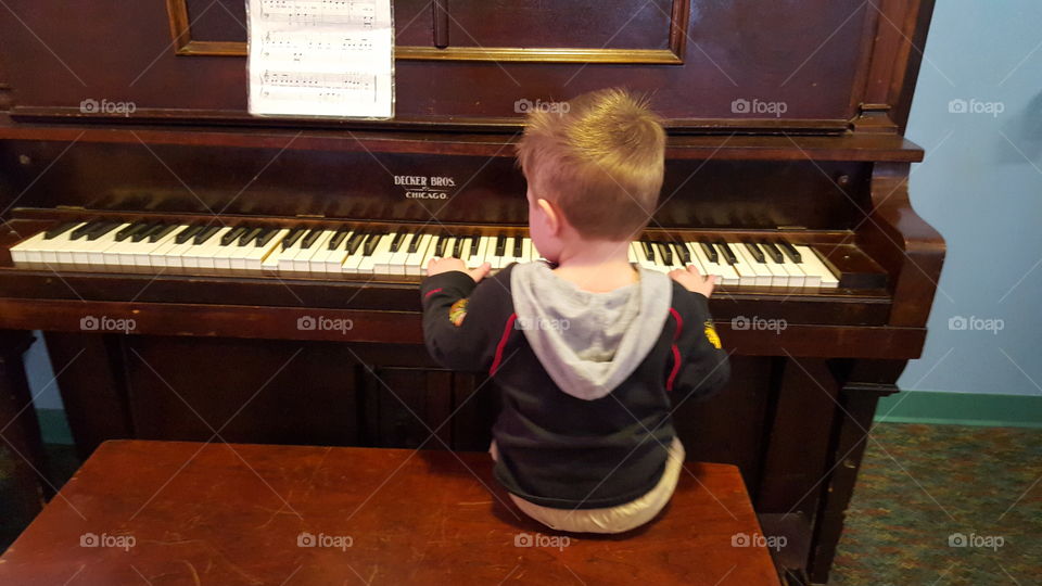 little boy playing piano