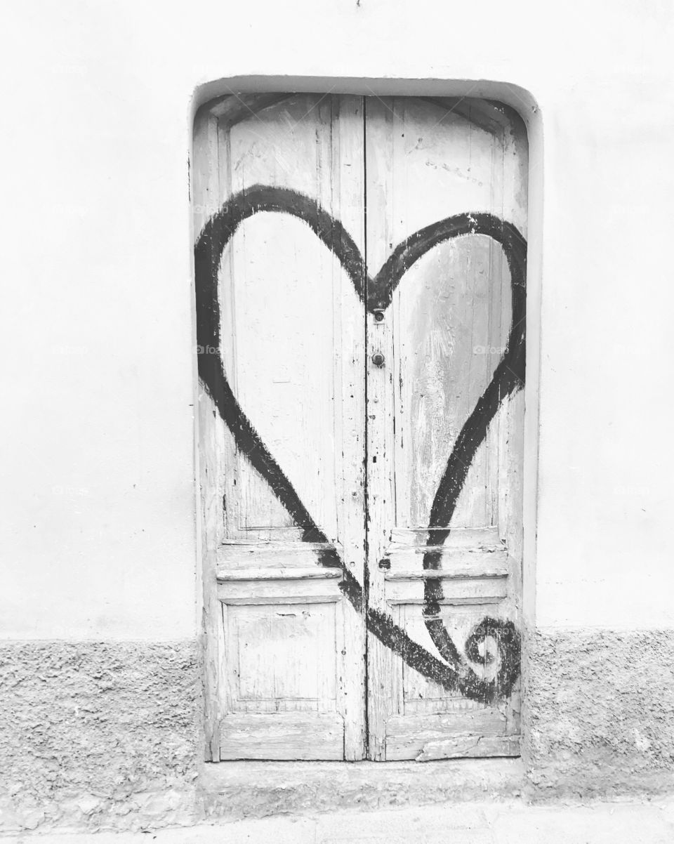Graffiti heart on a door along the river of Navigli, Milan. 
