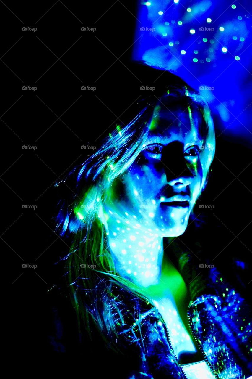Girl lighted with galaxy-light, green&blue