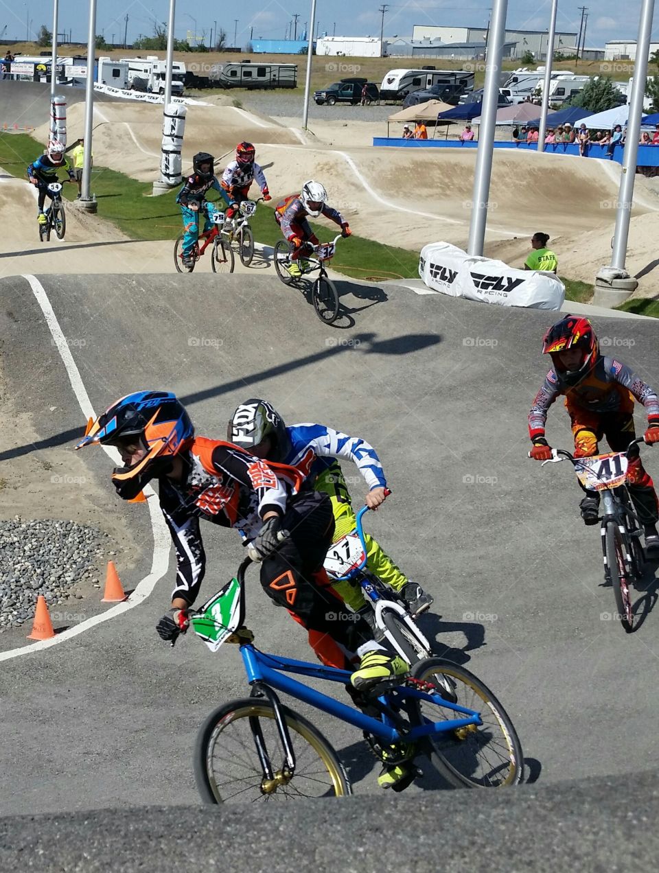 Youths Racing BMX Bikes on Outdoor Race Track During Competition