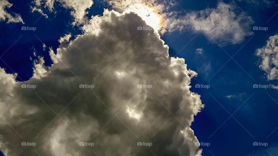 Cloudy sky with the sun between the clouds