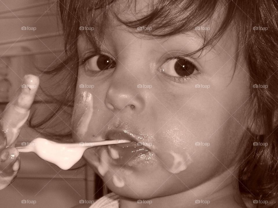 Little girl smudging her icecream all over her face