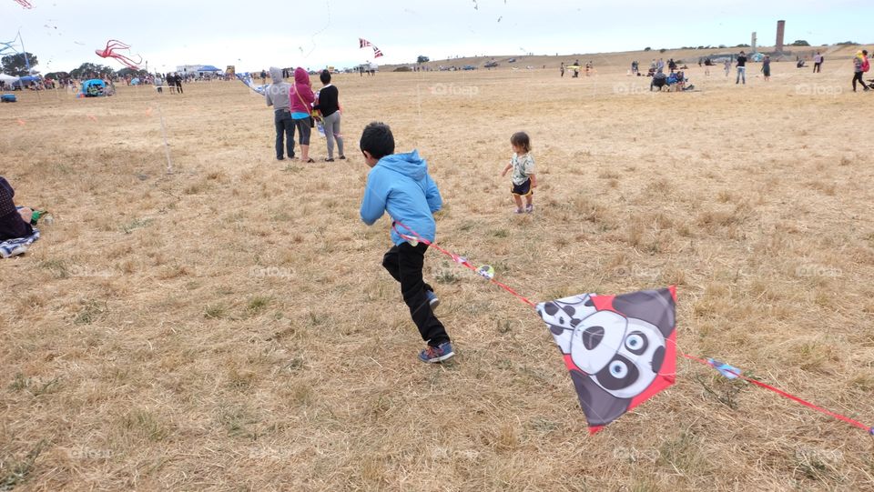 Kid trying to fly a kite