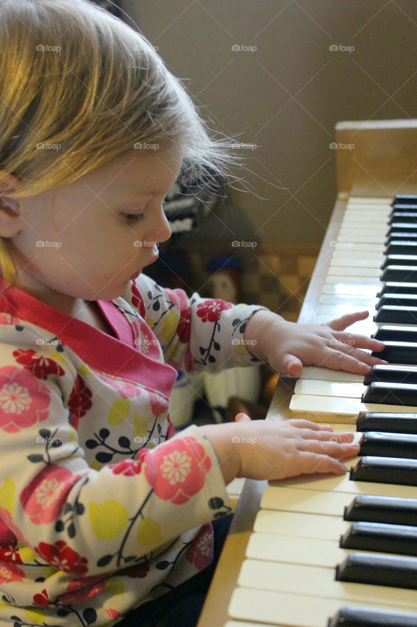 Close-up of girl playing piano