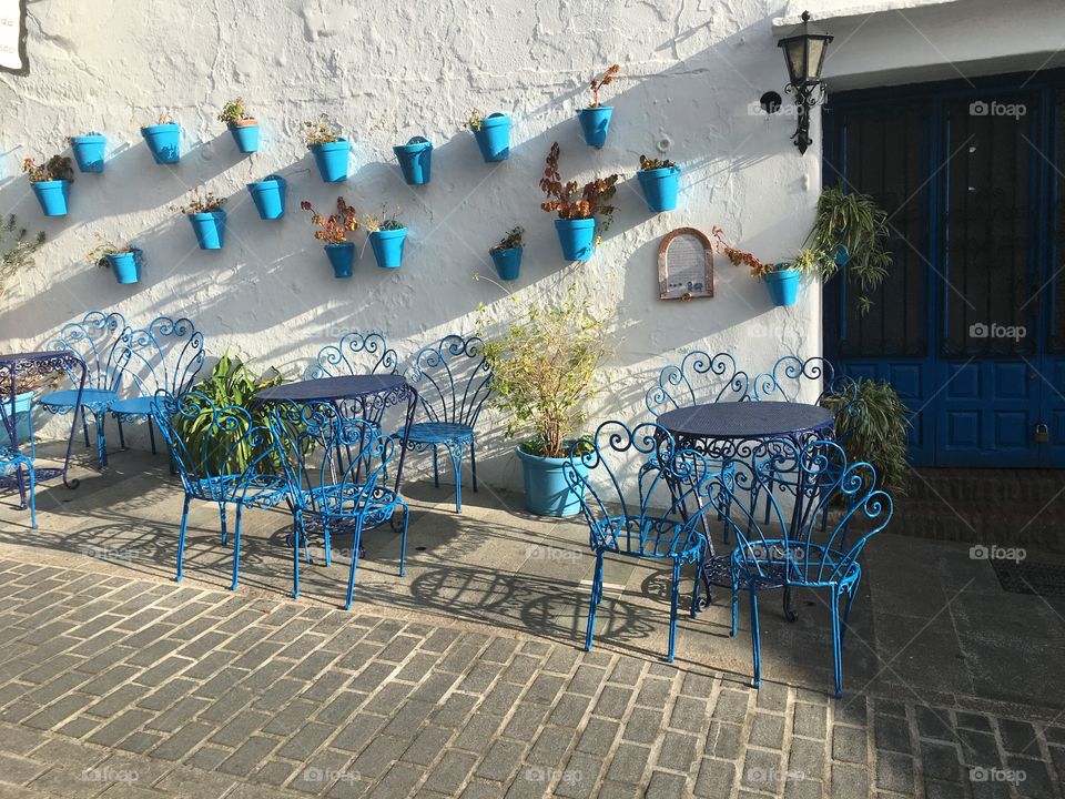 Blue and white cafe tables during siesta time.