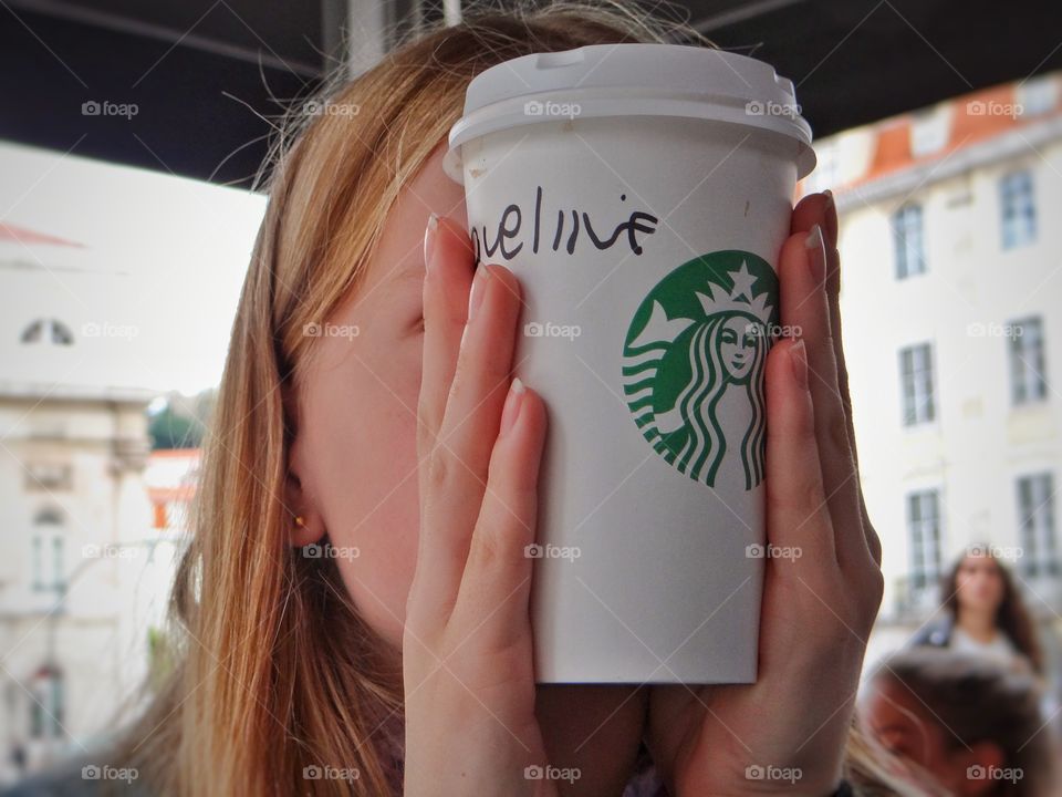 Behind Starbucks cup