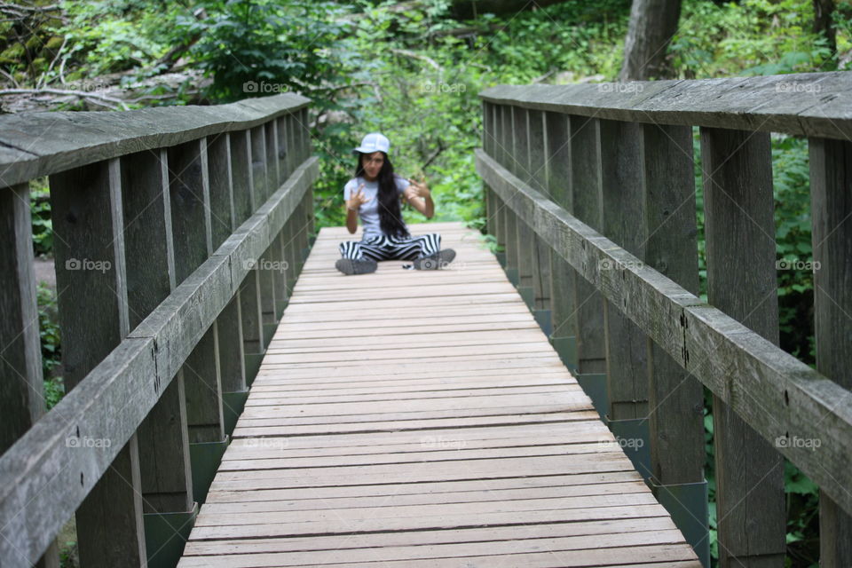 Teen on a wooden bridge