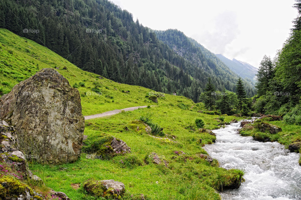 European alps landscape. Stream flowing though Schwarzachtal valley in zillertal alps. Austria.