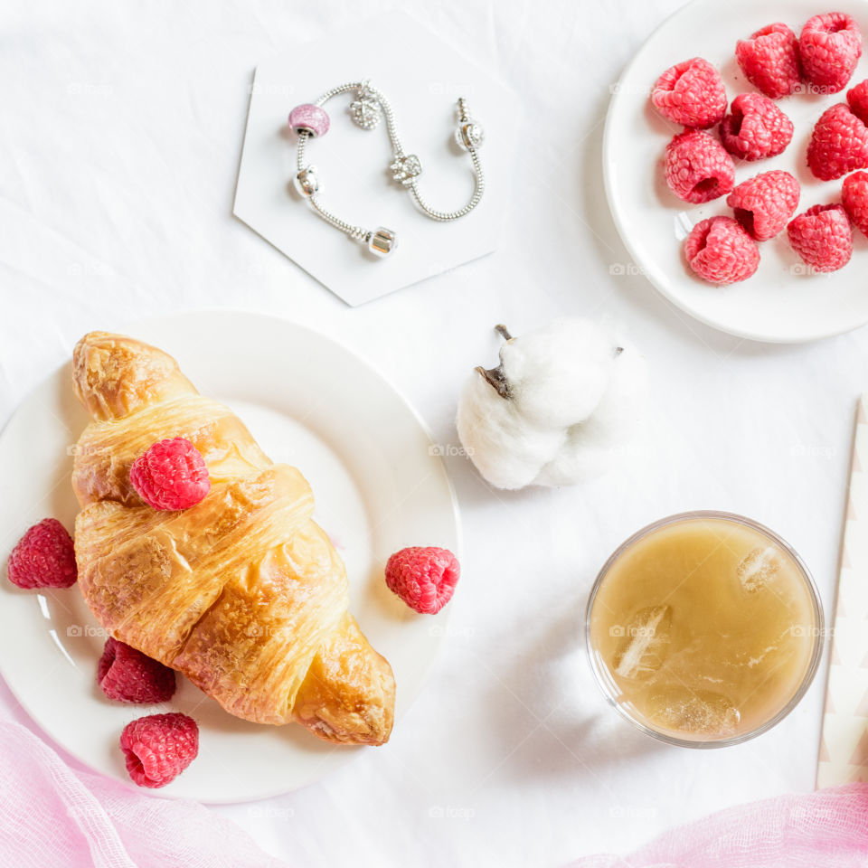 Flat lay with fresh raspberry and croissant 