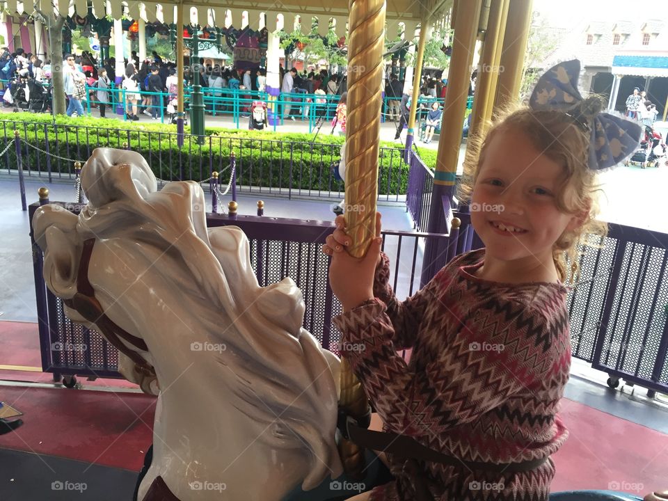 Little girl enjoying ride in amusement park