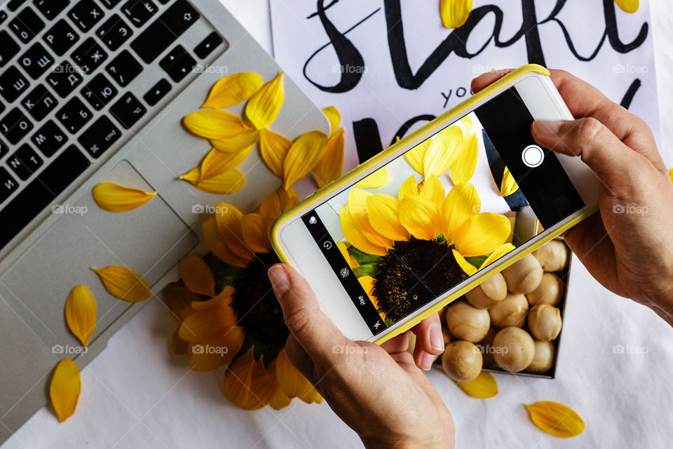 Woman using mobile phone and taking picture