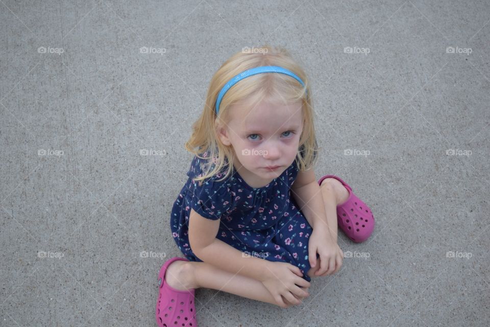Little girl crying on the sidewalk