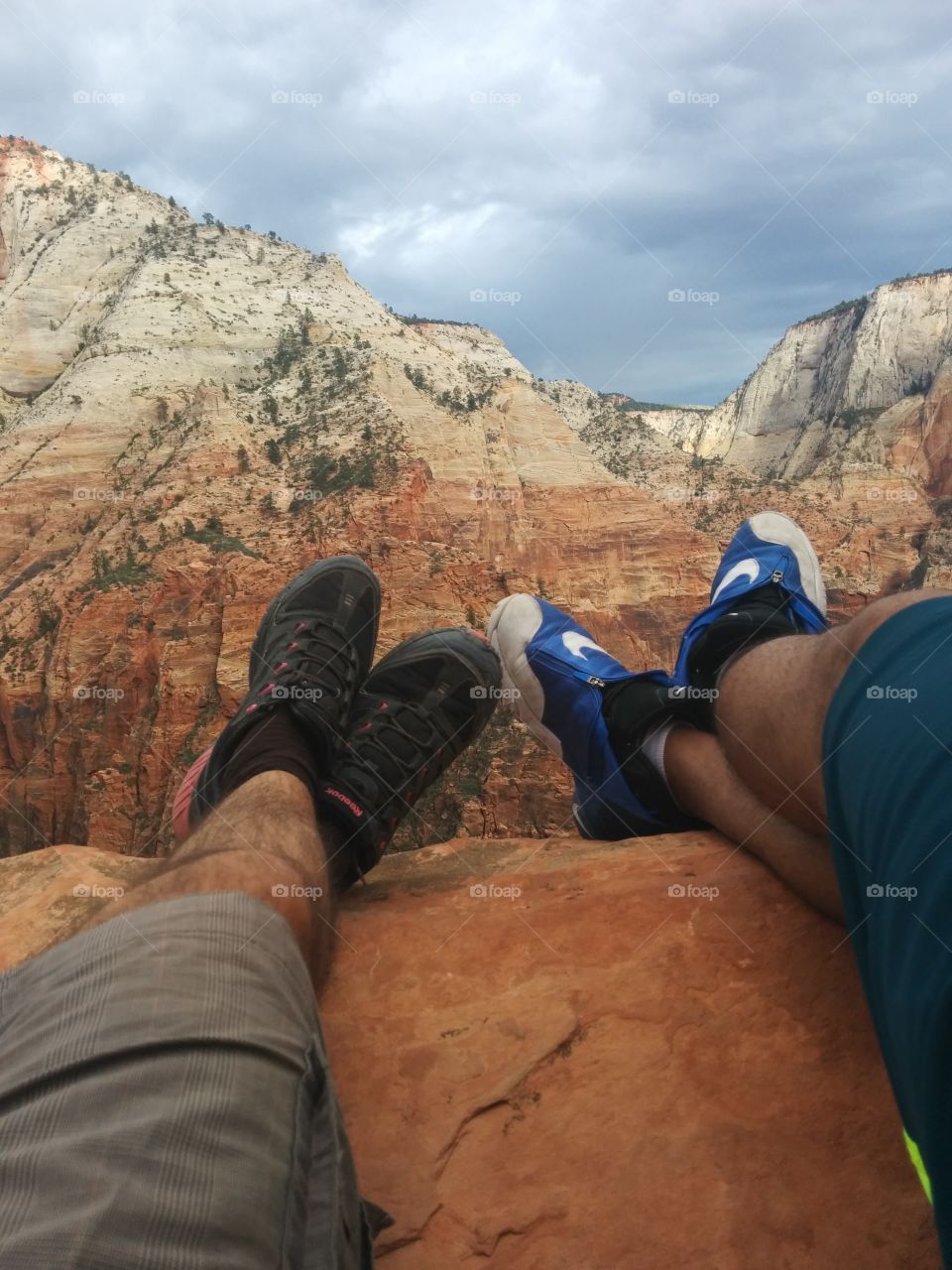 Hiking with a friend. After a strenuous hike with a friend, some relax enjoying our breathtaking prize