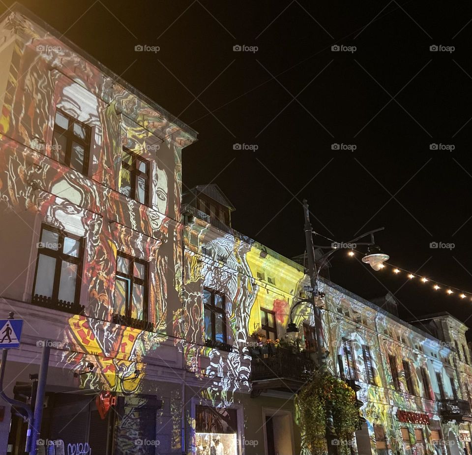 Vibrant projections light up historic facades during the Light Move Festival in Łódź, creating a mesmerizing blend of art and architecture. A magical celebration of color and creativity under the night sky.