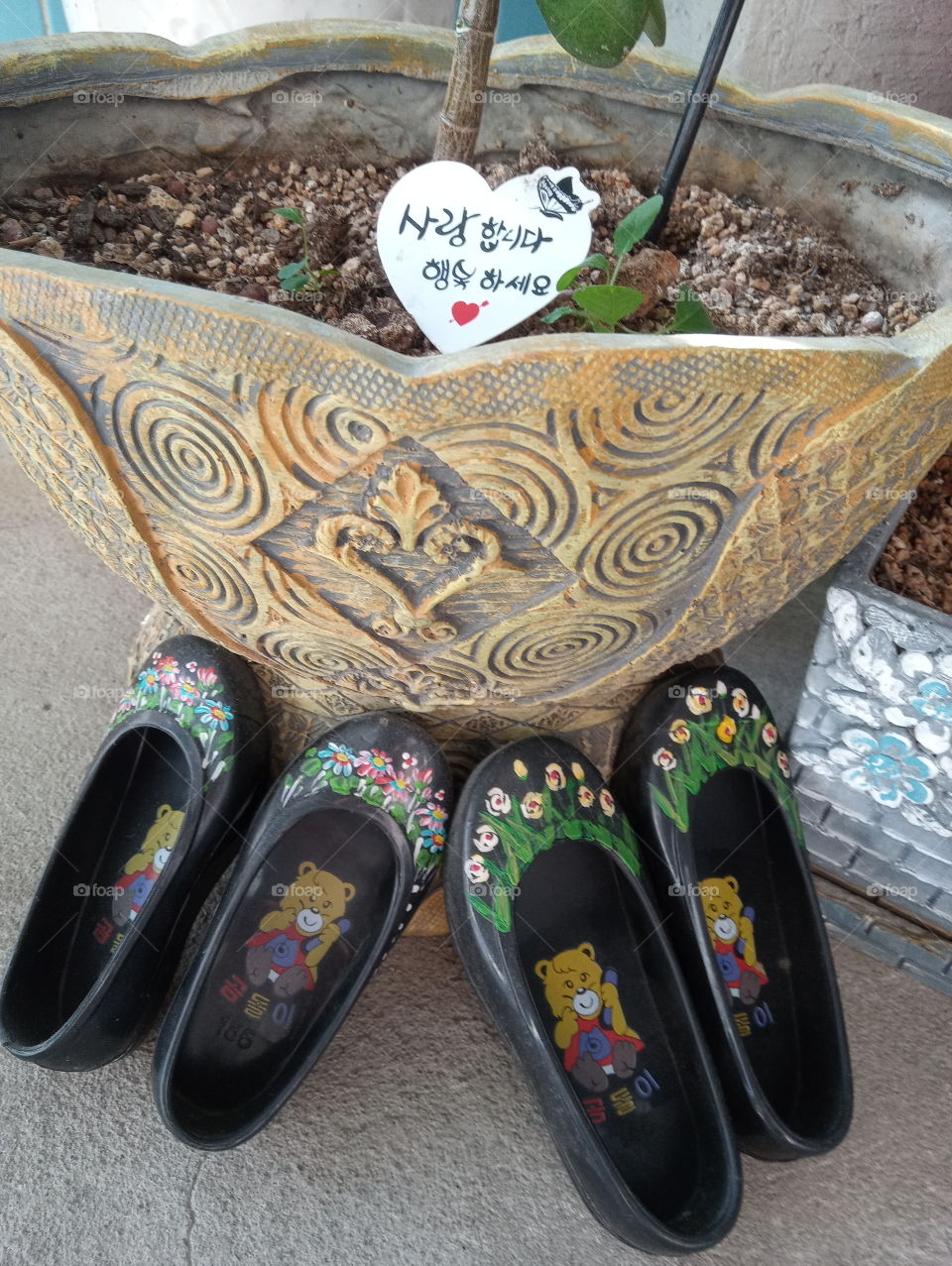 2 pairs of  little cuties sandals for kids. that  makes it even.  its have lovely flowers decoration on it.