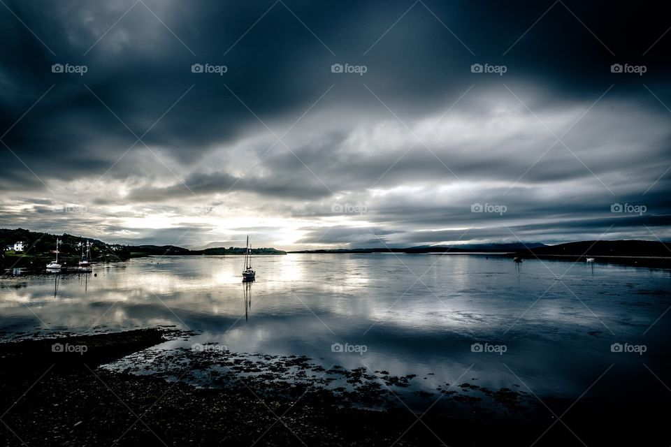 Yacht under stormy sky. A yacht moored under a stormy sky. 