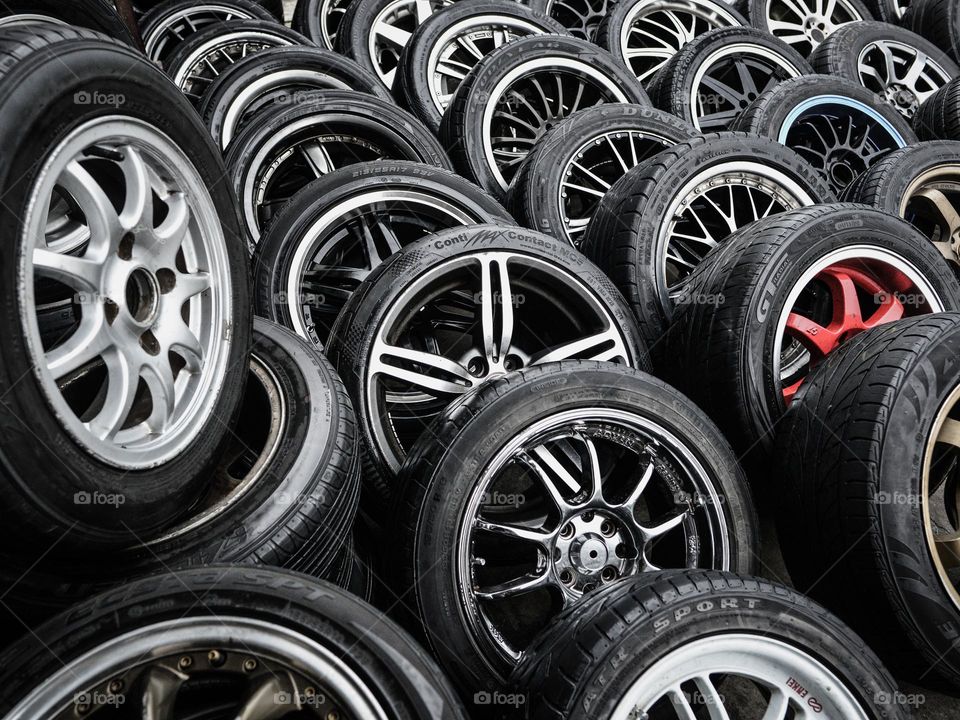 Wheels and tires arranged ay a automotive shop