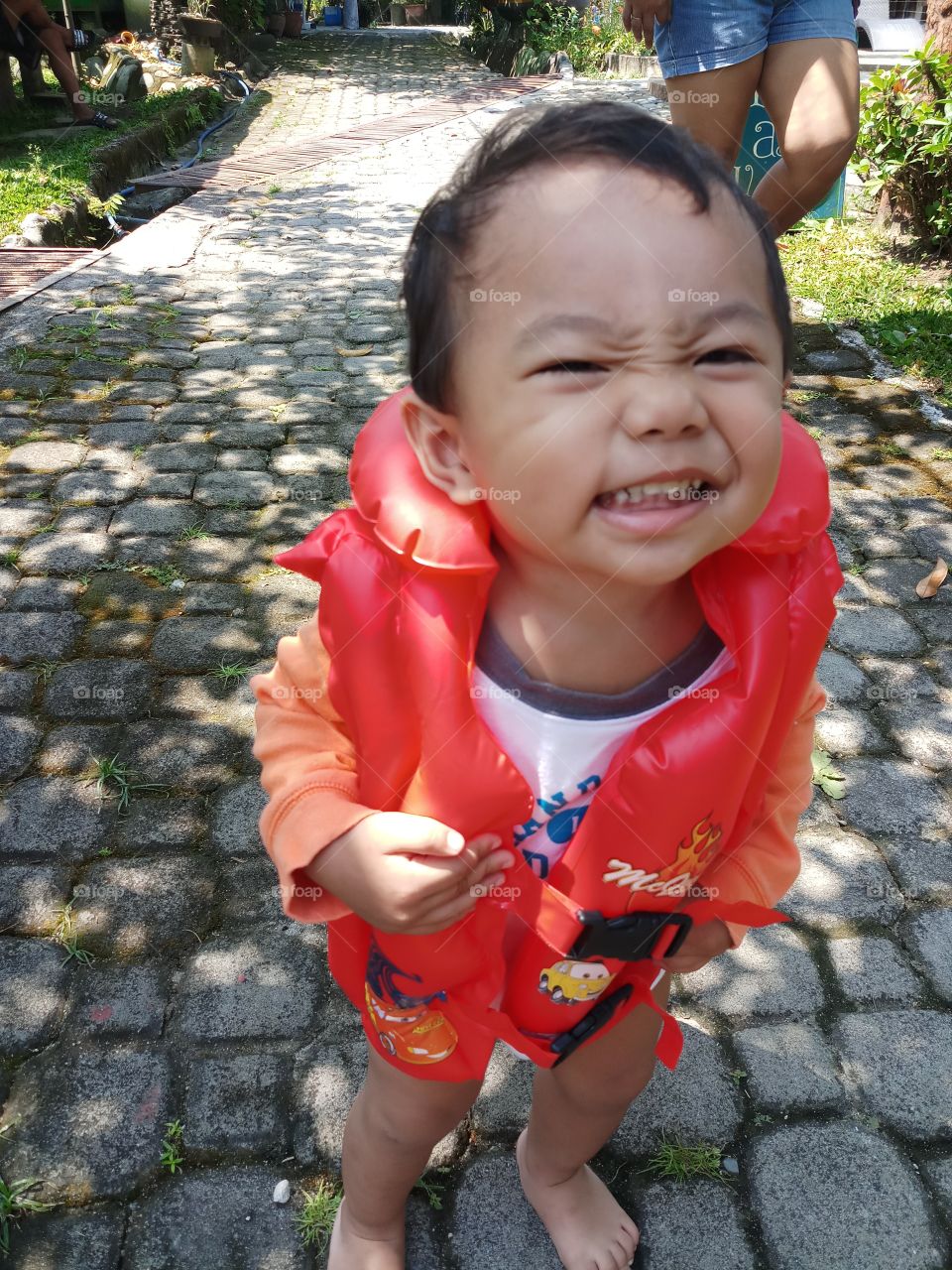 a toddler excited to go on swimming.