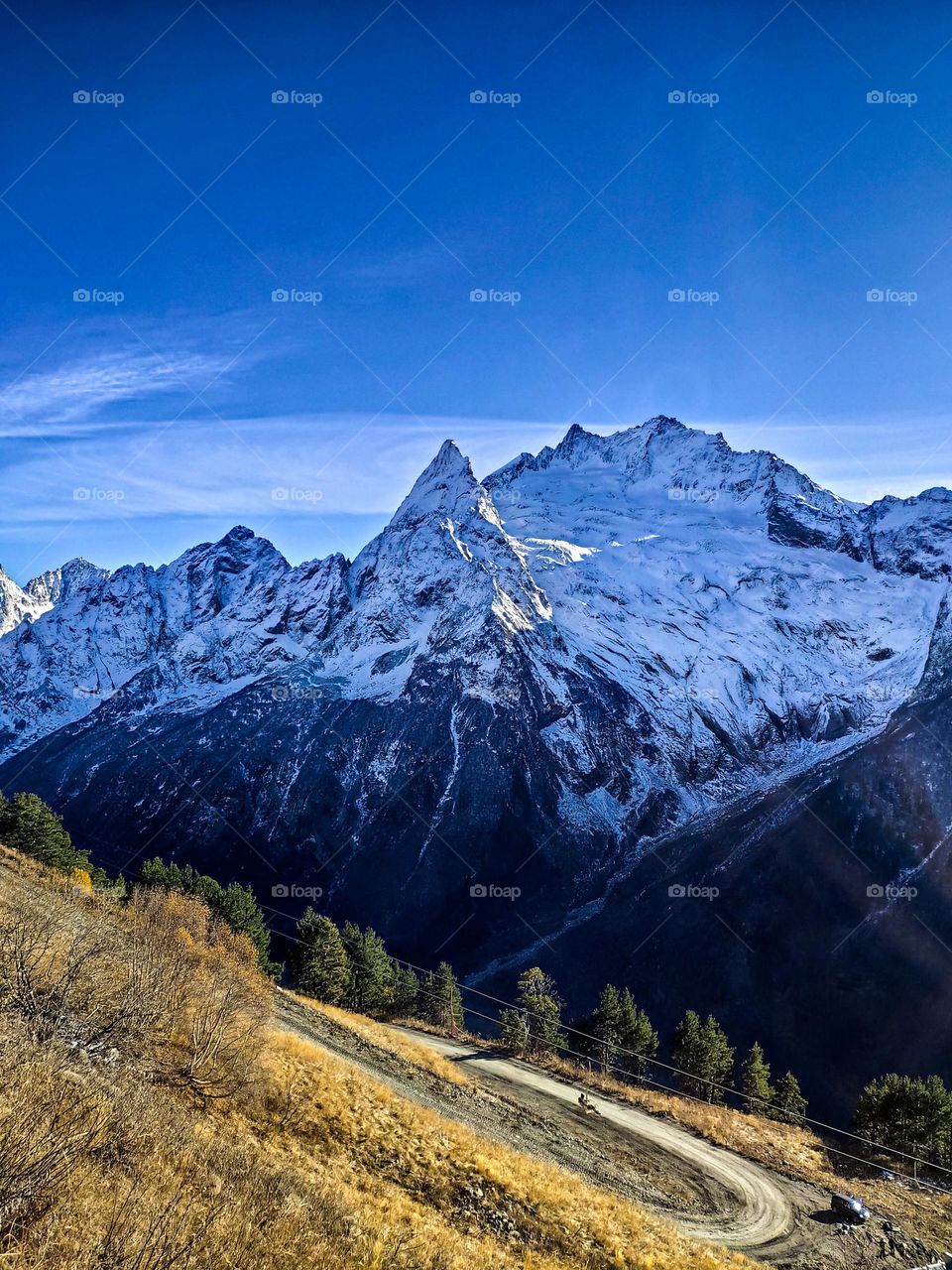 The road along the snow-capped mountains