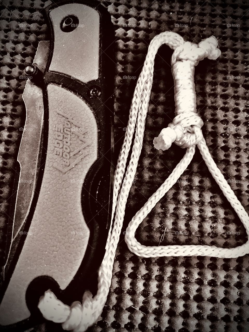 A folding pocket knife with homemade lanyard. The thin cord was added to prevent the knife from falling out of one’s hand since it is easy to drop it when utilizing it for a job.